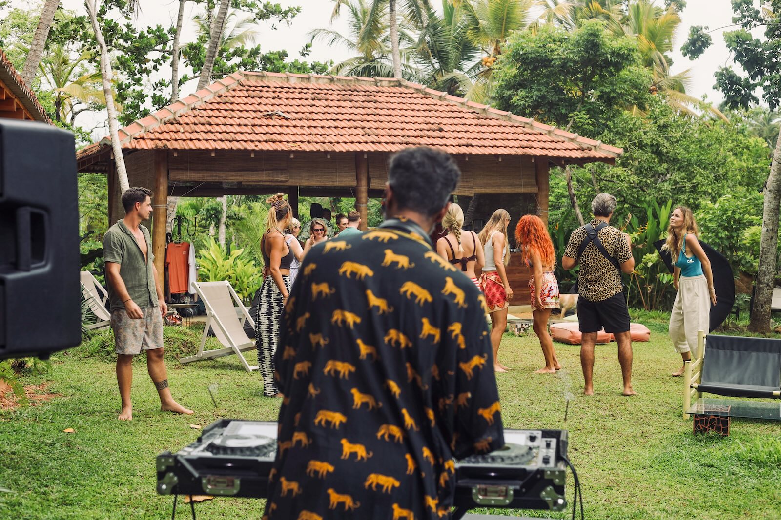 DJ playing to the garden — people dancing barefoot on the grass in front of the pavilion